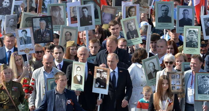 The president of the Russian Federation Vladimir Putin (in the center) during procession of Regional patriotic public organization Immortal Regiment Moscow along the Red Square