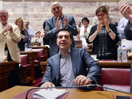 Greek prime minister Alexis Tsipras is applauded by lawmakers before addressing his parliamentary group meeting at the Greek Parliament in Athens