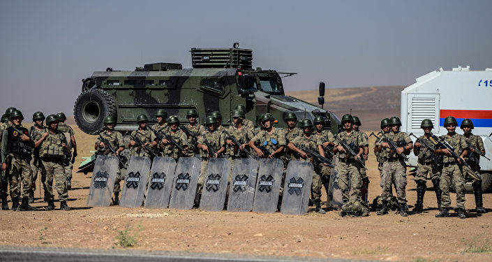 Turkish soldiers stand guar near the Turkey-Syrian border post in Sanliurfa