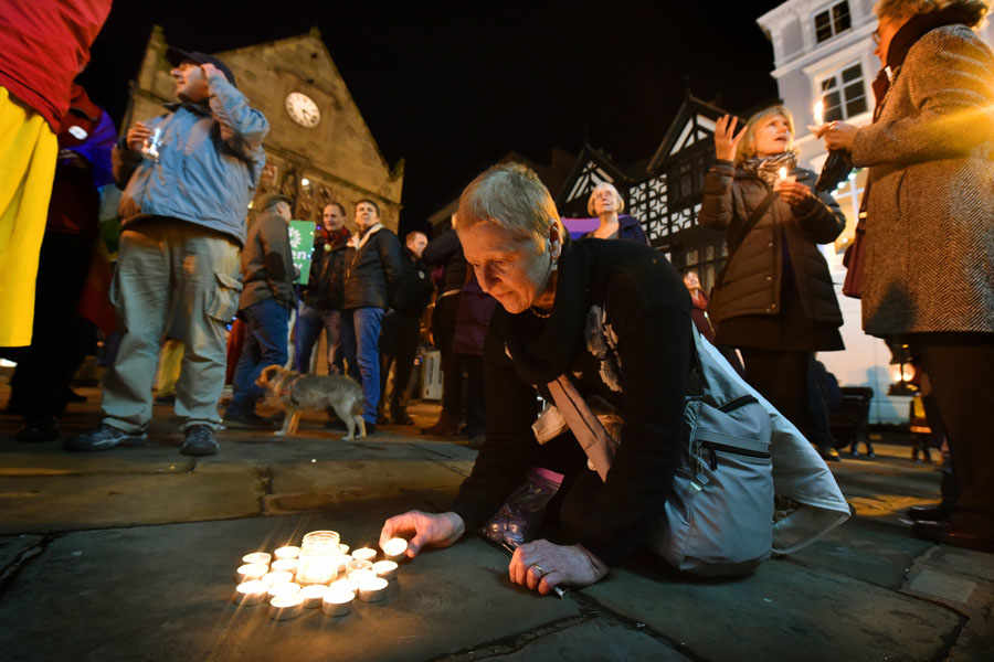 Jenna Kumiega from Shrewsbury lights a candle
