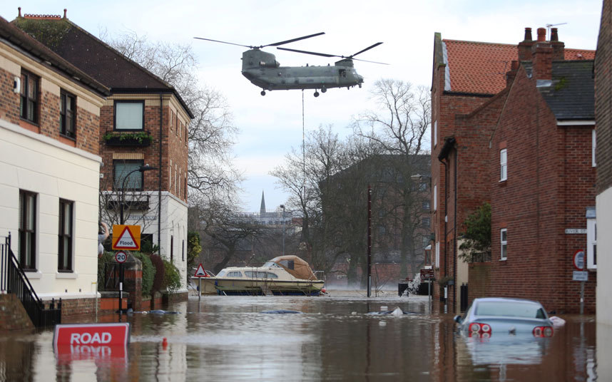 A Chinook helicopter delivers materials to repair to the flood defence systems in York, North Yorkshire