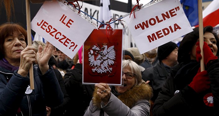 People gather during an anti-government demonstration for free media in front of the Polish television building in Warsaw, January 9, 2016