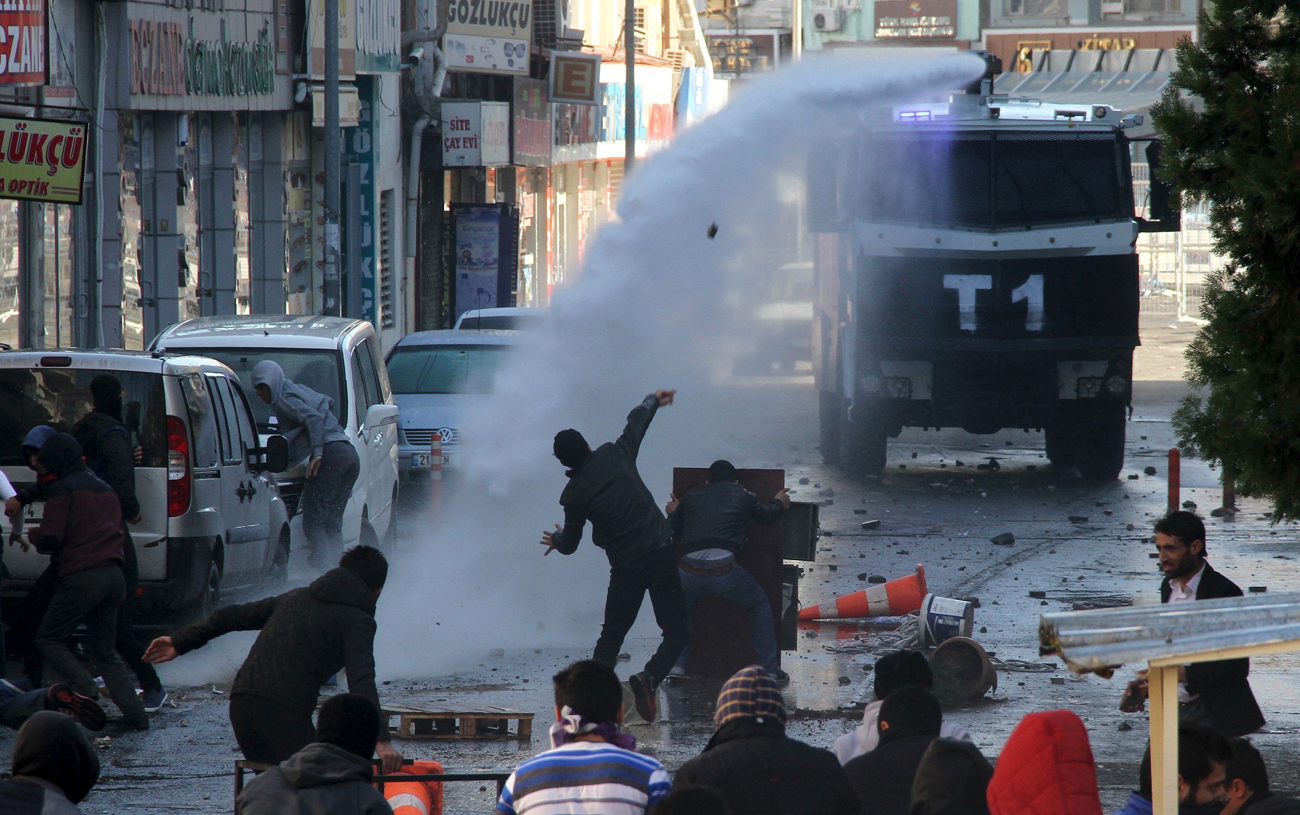 Riot police use a water cannon to disperse stone throwing Kurdish demonstrators during a protest against the curfew in Sur district, in the southeastern city of Diyarbakir, Turkey, December 22, 2015
