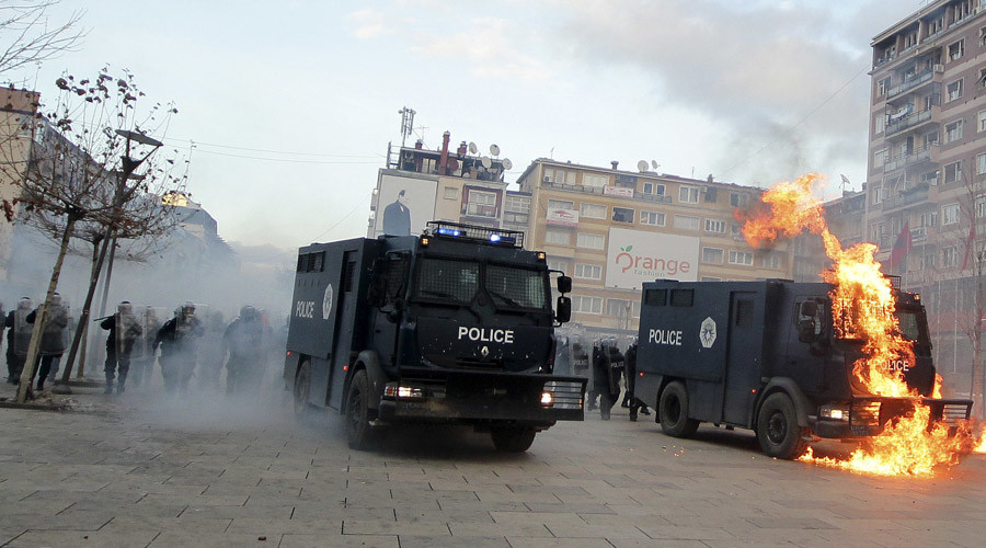 A police vehicle is set on fire by protesters during clashes in Pristina, Kosovo January 9, 2016. © Agron Beqiri 