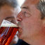 Nigel Farage drinks a beer as he attends the Autumn Racing and CAMRA Beer Festival