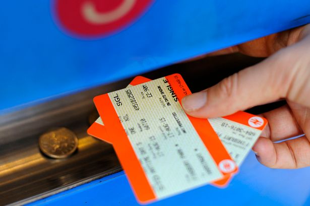 A person buying a train ticket