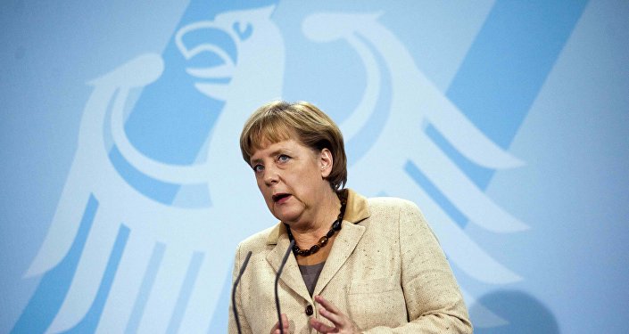 German Chancellor Angela Merkel  in front of Germany's heraldic eagle