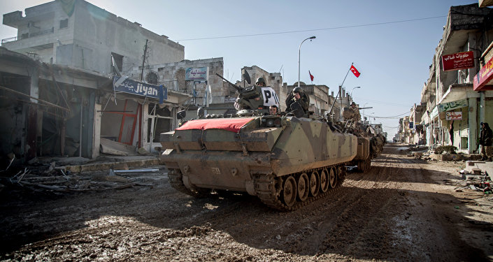Turkish army's armored vehicles and tanks drive in Syrian town of Ayn al-Arab, also known as Kobani, as they return from the Ottoman tomb in Syria, Sunday, Feb. 22, 2015