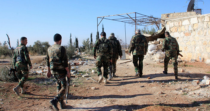 Syrian government forces inspect an area near the village of Khan Tuman, south from the provincial capital Aleppo, on December 22, 2015
