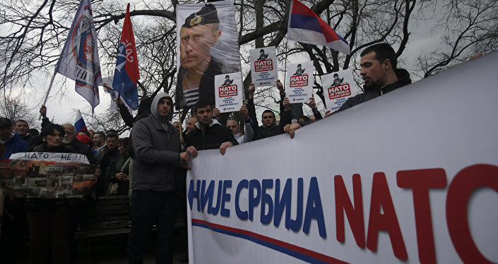 Protesters holding a banner that reads: Serbia is not NATO during a protest against NATO in downtown Belgrade, Serbia, Saturday, Feb. 20, 2016