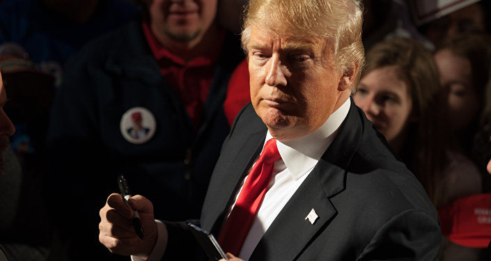 Republican presidential candidate Donald Trump signs autographs for supporters at the conclusion of a Donald Trump rally at Millington Regional Jetport on February 27, 2016 in Millington, Tennessee