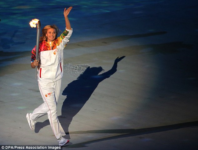 Sharapova carries the Olympic torch during the opening ceremony in Sochi