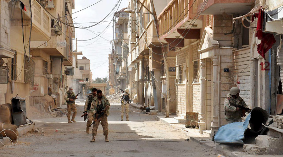 Forces loyal to Syria's President Bashar al-Assad walk with their weapons in Palmyra city after they recaptured it, in Homs Governorate in this handout picture provided by SANA on March 27, 2016. © SANA