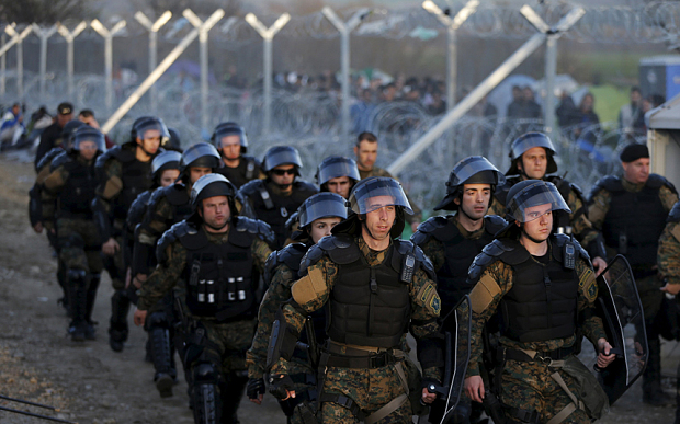 Macedonian riot policemen patrol at the Macedonian-Greek border in Gevgelija, Macedonia