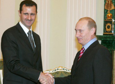 Russia's President Putin and Syrian President Bashar al-Assad shake hands as they meet in Moscow
