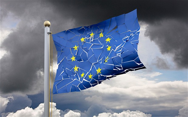 A eurozone flag flag that appears cracked with a stormy background