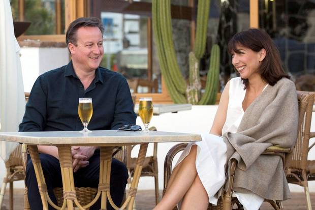 Prime Minister David Cameron and his wife Samantha pose for a photograph during their holiday in Playa Blanca, Lanzarote.