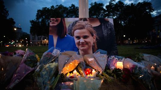 Flowers surround a picture of Jo Cox during a vigil in Parliament Square on June 16, 2016 in London, United Kingdom.