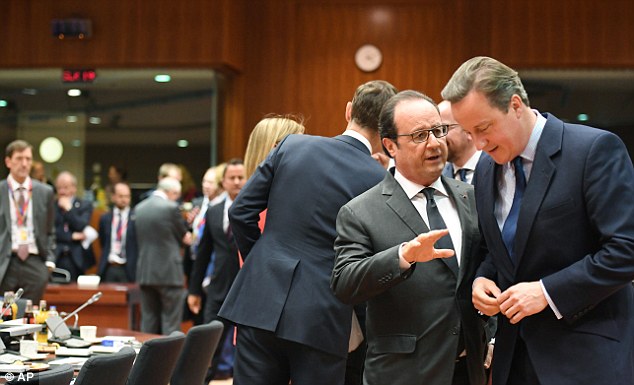 French President Francois Hollande has a quiet word with David Cameron at the EU summit in Brussels today
