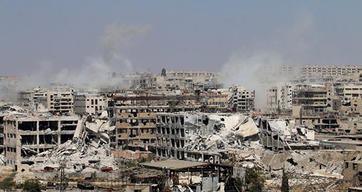 Smoke billows from buildings during an operation by Syrian government forces to retake control of the rebel-held district of Leramun, on the northwest outskirts of Aleppo, on July 26, 2016