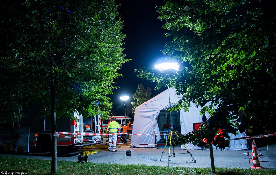 A mobile care and help center is erected in a parking area of a Kentucky Fried Chicken near the Olympia Einkaufzentrum (OEZ) after a shooting at the shopping mall