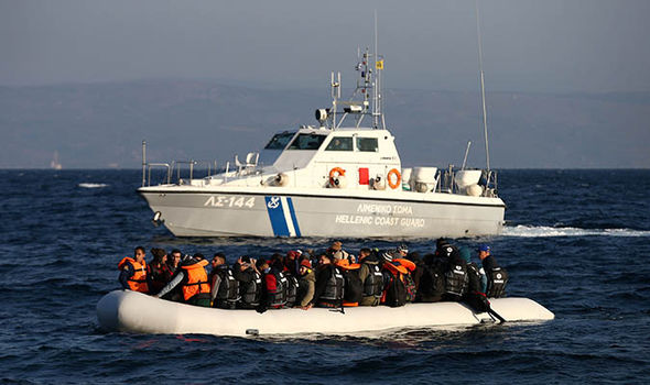 A coast guard boat rescues refugees from the sea off Greece
