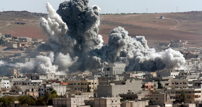 In this October 22, 2014, file photo, thick smoke from an airstrike by the US-led coalition rises in Kobani, Syria, as seen from a hilltop on the outskirts of Suruc, at the Turkey-Syria border.
