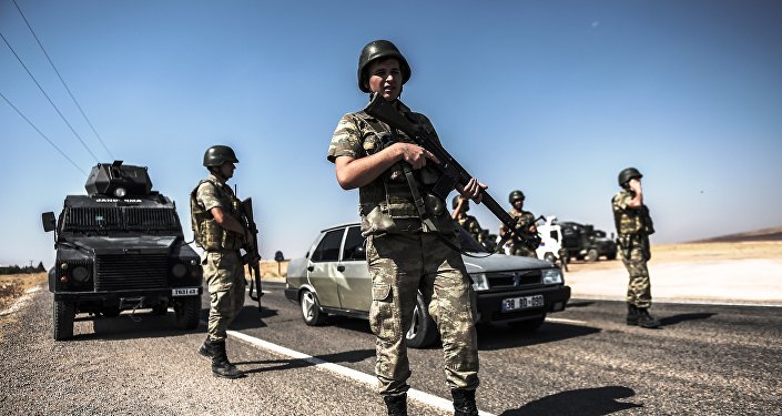 Turkish soldiers stand near the Turkey-Syrian border post in Sanliurfa, on September 4, 2015