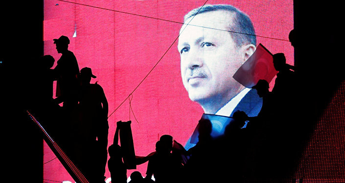 Turkish Supporters are silhouetted against a screan showing President Tayyip Erdogan during a pro-government demonstration in Ankara, Turkey, July 17, 2016.