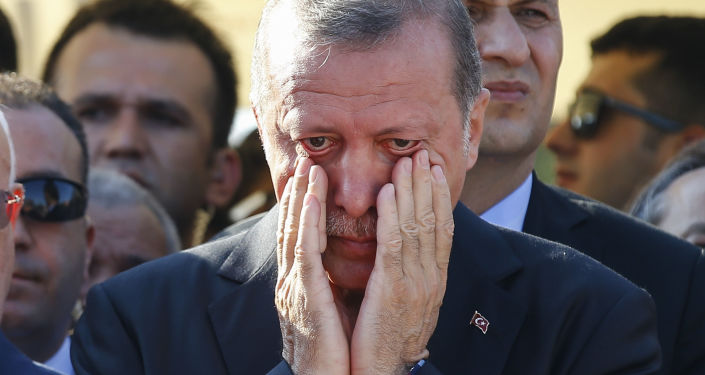 Turkish President Recep Tayyip Erdogan right, wipes his tears during the funeral of Mustafa Cambaz, Erol and Abdullah Olcak, killed Friday while protesting the attempted coup against Turkey's government, in Istanbul, Sunday, July 17, 2016.