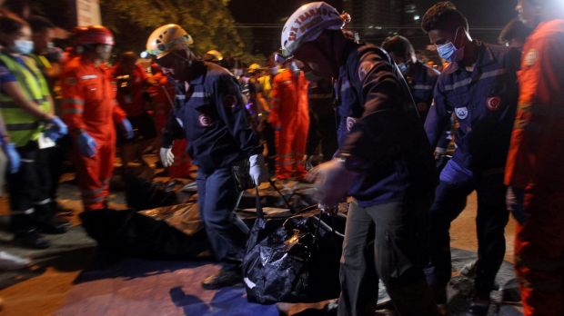 Rescuers carry a body bag after an explosion at a market in Davao City on Friday night.