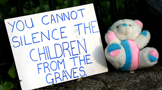 Sign held by protesters of the alck of investigation into the burial at Tuam. 