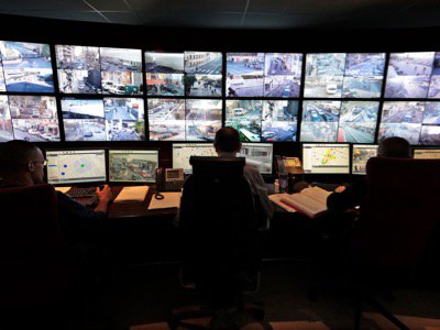 Municipal police officers watch screens in the video surveillance control room of the municipal police supervision centre in Nice