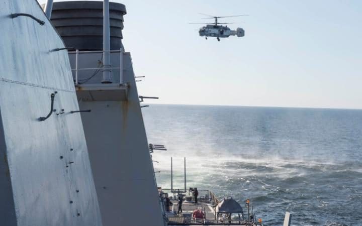 A Russian Kamov KA-27 Helix closely surveils the USS Donald Cook (DDG 75),an Arleigh Burke-class guided-missile destroyer, operating in the Baltic Sea April 12, 2016.