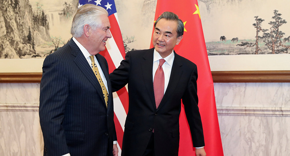 Chinese Foreign Minister Wang Yi (R) talks with U.S. Secretary of State Rex Tillerson at Diaoyutai State Guesthouse on March 18, 2017 in Beijing, China