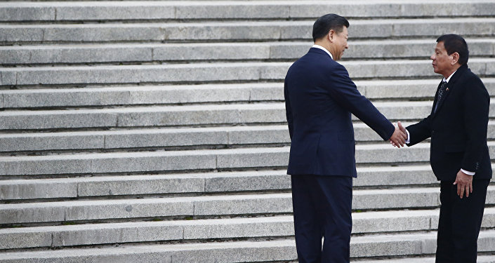 President of the Philippines Rodrigo Duterte (R) and Chinese President Xi Jinping shake hands as they attend a welcoming ceremony at the Great Hall of the People in Beijing, China, October 20, 2016.