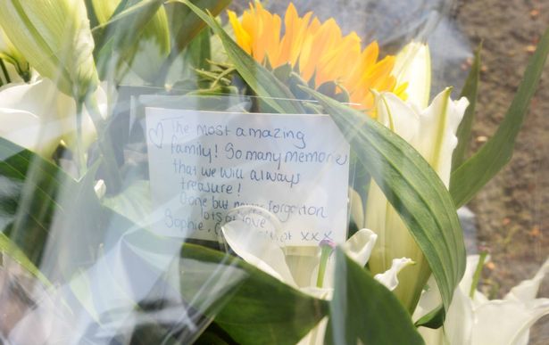 Flowers left in tribute to an 'amazing family'.