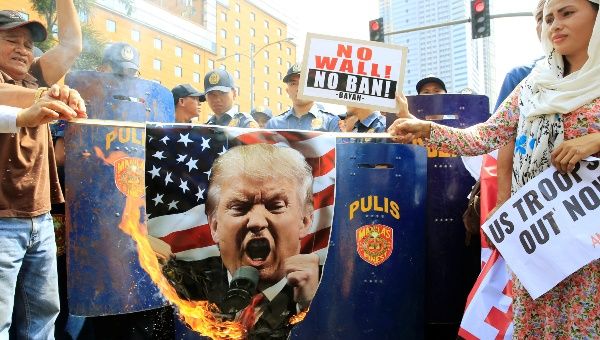 Filipino activists burn a portrait of U.S. President Donald Trump during a protest against U.S. immigration policies outside the U.S. embassy in metro Manila, Philippines, Feb. 4, 2017.