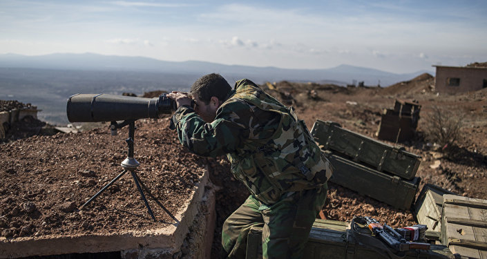 A soldier of the Syrian Arab Army at an observation post at the frontline in the al-Kom village of the Quneitra province in Syria