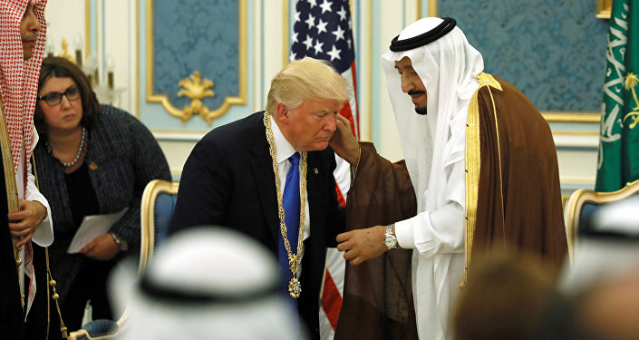 Saudi Arabia's King Salman bin Abdulaziz Al Saud (R) presents U.S. President Donald Trump (C) with the Collar of Abdulaziz Al Saud Medal at the Royal Court in Riyadh, Saudi Arabia May 20, 2017. Picture taken May 20, 2017