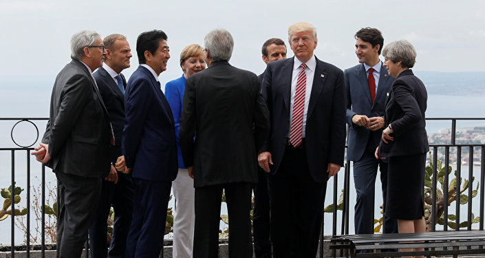 U.S. President Donald Trump gathers with (L-R) European Commission President Jean-Claude Juncker, European Council President Donald Tusk, Japanese Prime Minister Shinzo Abe, German Chancellor Angela Merkel, Italian Prime Minister Paolo Gentiloni, French President Emmanuel Macron, Canadian Prime Minister Justin Trudeau and Britain’s Prime Minister Theresa May as they attend the G7 Summit in Taormina, Sicily, Italy, May 26, 2017.