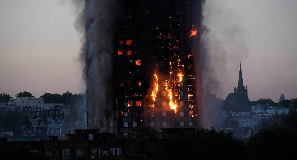 Flames and smoke billow as firefighters deal with a serious fire in a tower block at Latimer Road in West London, Britain June 14, 2017