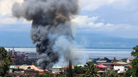 Thick smoke billows from a residential area after an airstrike in Lanao Del Sur Province, the Philippines, May 27, 2017. © Global Look Press