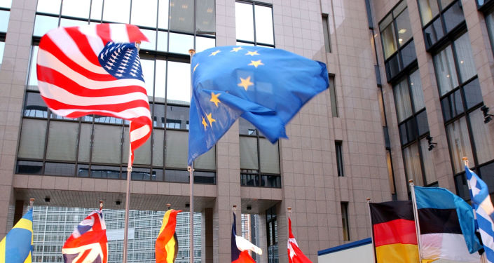 The US and EU flags, top left and right, fly in separate directions at the European Council building in Brussels