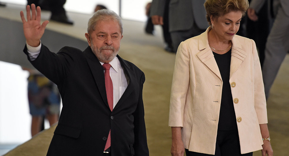 Former Brazilian president Luiz Inacio Lula da Silva (L) gestures next to Dilma Rousseff