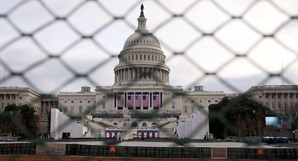 The U.S. Capitol building is seen behind a security fence in Washington, U.S., January 19, 2017