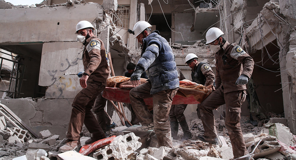 Syrian civil defence volunteers, known as the White Helmets, search for survivors following reported government airstrike on the rebel-held neighbourhood of Tishrin, on the northeastern outskirts of the capital Damascus