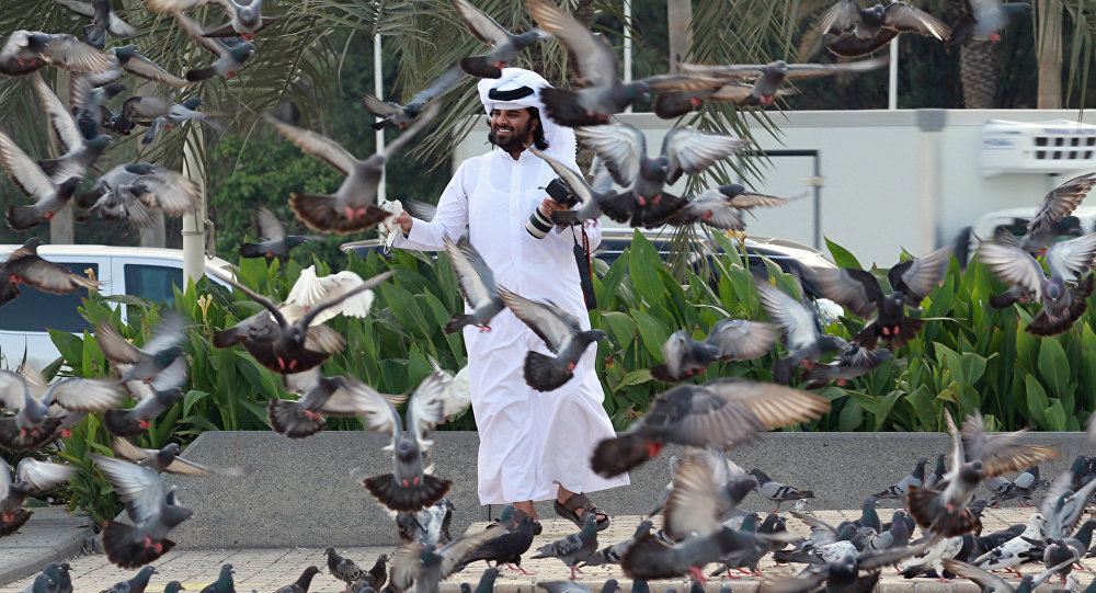 A man looks at pigeons at Souq Waqif market in Doha, Qatar, June 6, 2017.