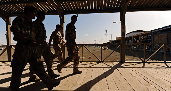 UK soldiers walk at a base in Kandahar on May 6, 2010.