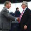 EU Commission president Jean-Claude Juncker (R) shakes hands as he talks with former leader of the UK Independence Party (UKIP) Nigel Farage (L) prior to a debate on the conclusions of the last European Council, at the European Parliament in Strasbourg